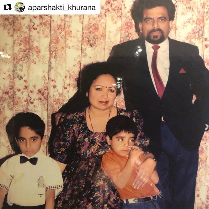 Can you identify this cute toddler with a bow tie? The cute kid made his debut in 2012 with Vicky Donor and went on to star in path-breaking films like Dum Laga Ke Haisha, Shubh Mangal Saavdhan, Andhadhun, Badhaai Ho and the recently released Dream Girl. His younger brother is also a stellar actor.
(In Picture: Ayushmann Khurrana, brother Aparshakti Khurana with their father P. Khurrana and mother Poonam)