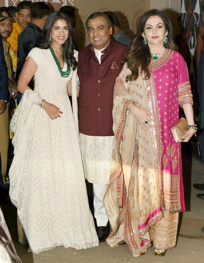 At Amitabh Bachchan's Diwali bash, Nita Ambani wore a fuchsia pink salwar suit and looked stunning in the ethnic attire. She paired her outfit with golden sharara pants and complimented it with an emerald green neckpiece. Picture/Yogen Shah
In picture: Nita Ambani is all smiles, as she poses for a photo with husband Mukesh and Anant's friend Radhika Merchant.