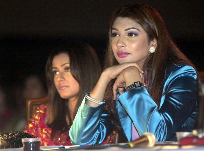Former Miss World winner Yukta Mookhey (R) and film actress Namrata Shirodkar (L), both members of the jury, watch the Mr India 2001 competition in Calcutta, February 24, 2001.