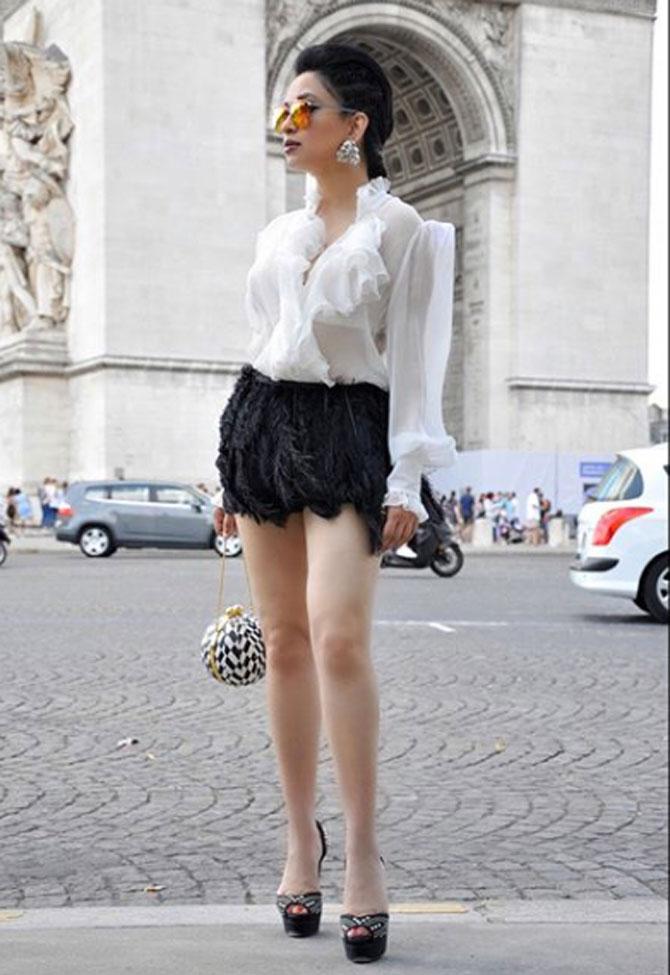 The Mumbai socialite wore a ruffled white shirt with a black short skirt and carried a black and white checkered clutch. She accessorised the look with silver earrings and sunglasses. The picture was taken in Paris.