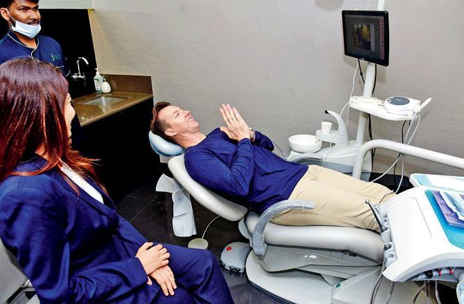Australian cricketer Brett Lee seems to be saying a little prayer at a dental care centre in Bandra. Pic/Bipin Kokate