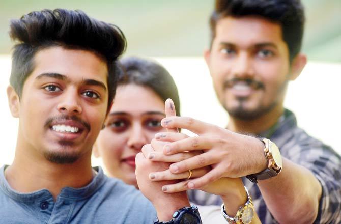 Alpesh Kherade, 18, cast his vote for the first time at TMC School in Thane. Kherade started out confused in the morning but later googled all election related information before heading to the booth. Pics/Sameer Markande