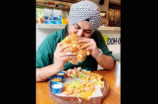 Abheet Singh negotiates bites into the WTF burger