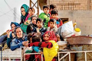 Syrians flee with their belongings from town Ras al-Ain. Pic/AFP