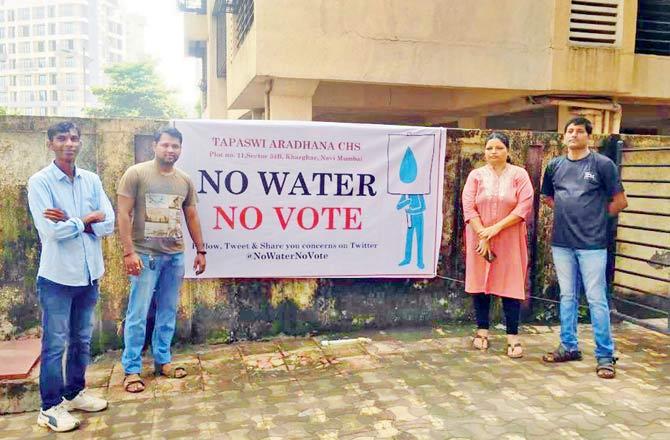 Residents of Tapaswi Aradhana housing society with a banner stating they will opt for NOTA