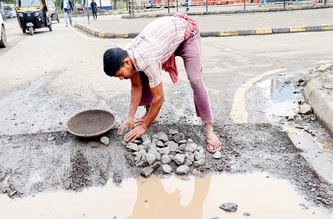 After filling it with muck, the CIDCO contractor covers it up with stones and gravel