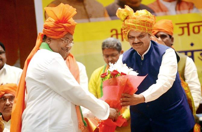 BJP leader Chandarakant Patil (left) greets Devendra Fadnavis on Wednesday