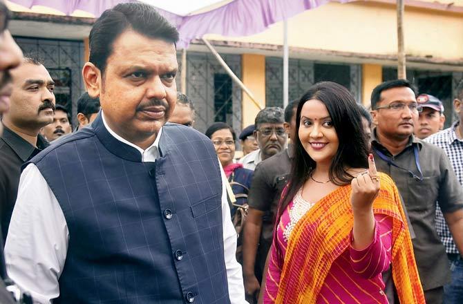 Chief Minister Devendra Fadnavis and wife Amruta after casting their votes in Nagpur. Pics/Pradeep Dhivar