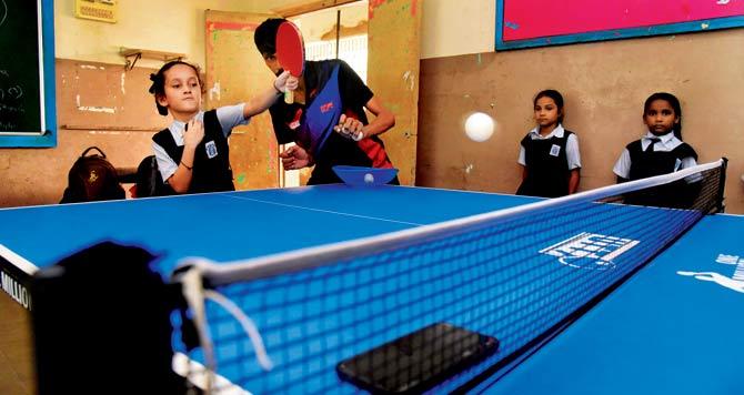 Table tennis coach Govind Ghadi trains six and seven-year-olds at Nityanand Marg English MPS School in Andheri East. Pic/Nimesh Dave