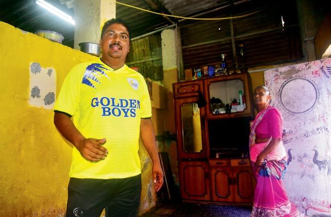 Colaba Municipal School football coach Jagdeep Dattaram Dhanu, 37, with his mother at their Macchimar Nagar home. Pic/Atul Kamble