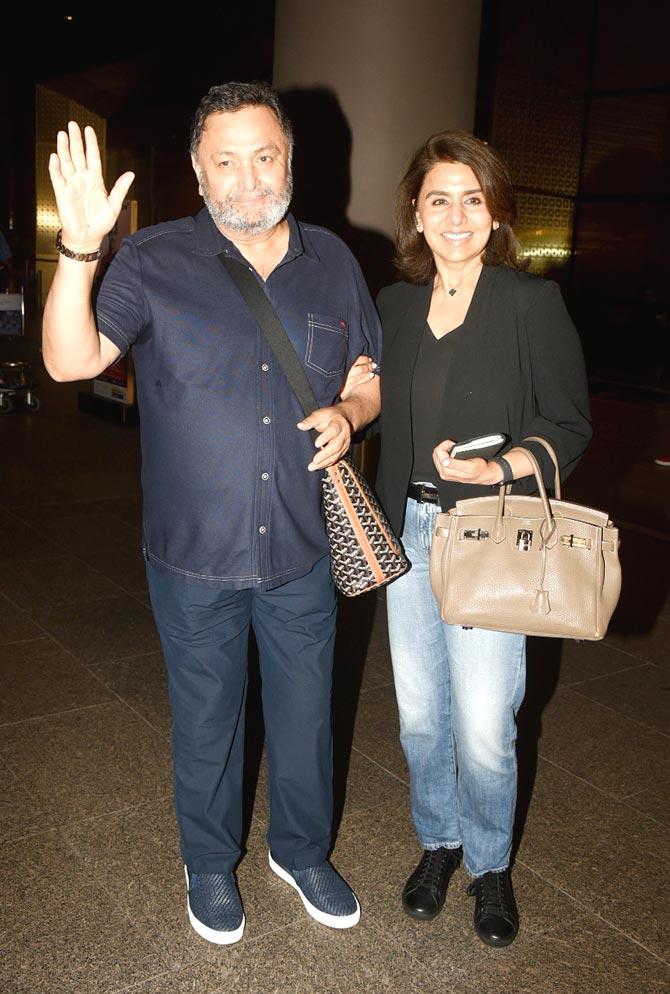 Rishi Kapoor had been in the US for over 11 months for his cancer treatment, and his wife, veteran actress Neetu has been by him through it all.
In picture: Rishi Kapoor waves at the photographers as he posed with wife Neetu at Mumbai airport.