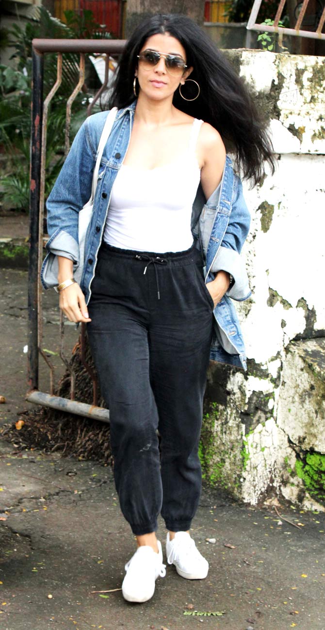 Nimrat Kaur was snapped at a salon in Juhu, Mumbai. The actress opted for white camisole top, paired with a denim jacket and joggers pants for the outing. She completed her casual look with white sneakers during the outing. All pictures/Yogen Shah