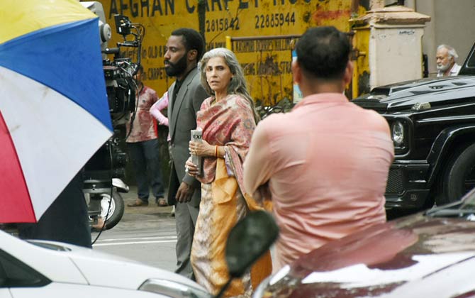 The team of Tenet was spotted shooting for the project at the Gateway of India on Monday. Christopher Nolan was joined by Dimple Kapadia and Robert Pattinson. They also shot at Colaba Causeway, Royal Bombay Yacht Club and on the streets near the famous Taj Mahal Hotel.
In picture: Dimple Kapadia with John David Washington.