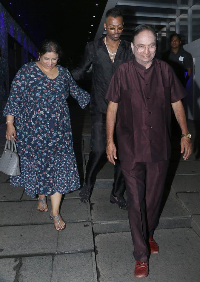 Hardik Pandya's mother looked elegant in a blue dress and his dad looked classy in maroon pants and shirt.