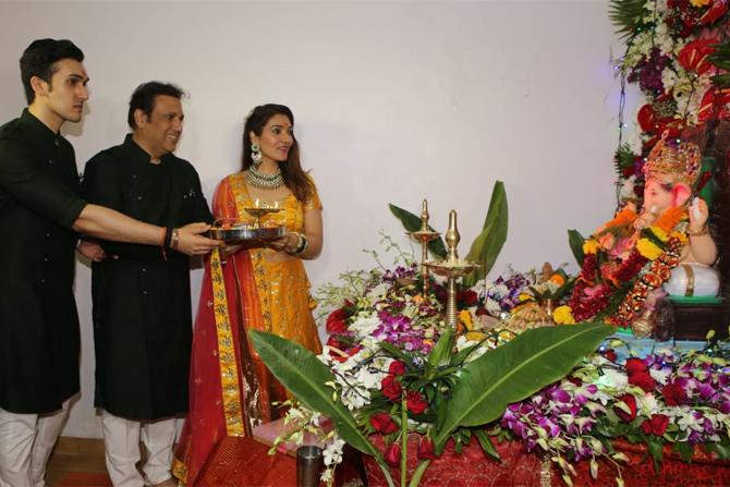 Govinda along with son Yashvardhan Ahuja and daughter Tina Ahuja were snapped worshipping the idol. The Hero No.1's family celebrates this festival every year at their Juhu residence.