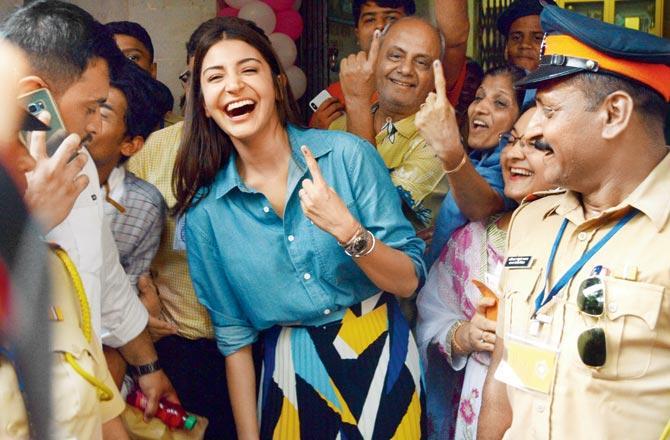 Anushka Sharma offers voters at a polling station in Versova a frame-worthy of the album when she poses with them after casting her vote. Pic/Satej Shinde