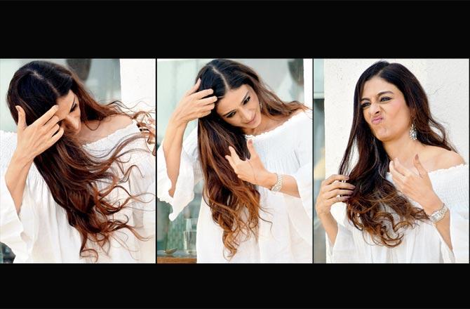 Tabu makes an attempt to tame her lustrous hair before the photographers at the promotion of her new film in Juhu. Pics/Ashish Raje