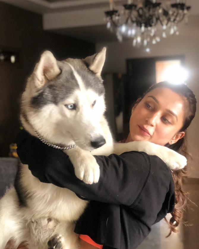 In picture: Mimi Chakraborty, who is seen sporting a black full-sleeves crop top looks adorable as she plays with her pet dog during the Valentine week. While sharing the picture, Mimi said that she doesn't keep a track of Valentines week but a warm hug from her pet dog is definitely a 'Hug Day' for her