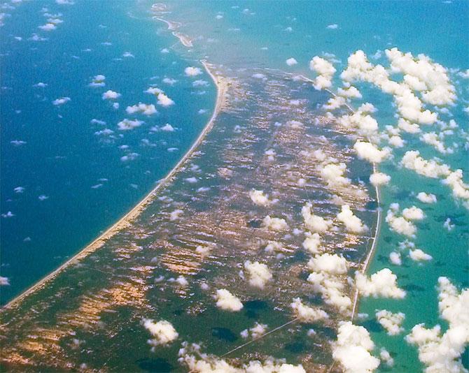 Adam's Bridge, Tamil Nadu: Adam's Bridge, also called Lord Rama's bridge is a chain of shoals between the islands of Mannar, near northwestern Sri Lanka, and Rameshwaram off the southeastern coast of India. The legend goes that Ramayana Ravana, the King of Lanka abducted Sita, the wife of Lord Rama. Lord Rama then assembled an army who helped him build a bridge between the southern-most tip of India and Sri Lanka. This bridge was eponymously named Ram Setu. Geologists say that Rama Setu was built naturally and are actually a chain of limestone shoals however, they could not prove the same.