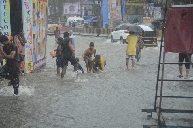 In the picture, people wade through waterlogged streets in Ville Parle
(Picture courtesy/Sneha Kharabe)