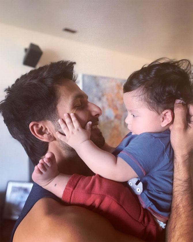 Shahid Kapoor shared this picture of munchkin Zain Kapoor. A beautiful father-son moment captured that will surely make you fall in love with it. Shahid is smiling with happiness, while Zain's playful nature is evident in the frame. Shahid captioned the image: 