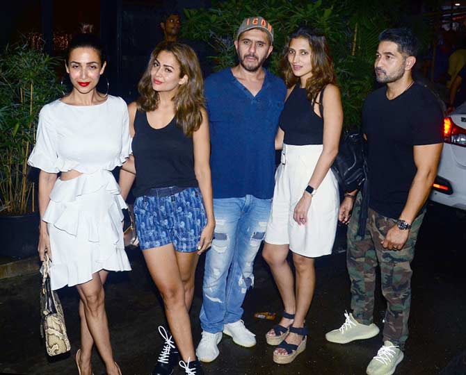 Amrita Arora too opted for a casual attire - she was seen wearing a blue top, paired with denim shorts and black ankle-length lace-up boots for the outing.