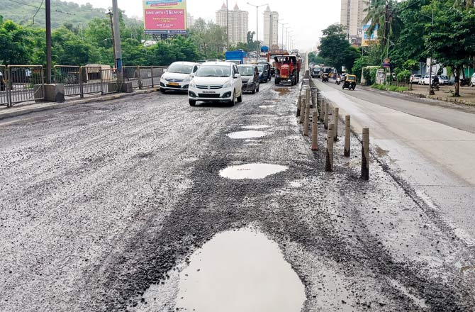 A pothole-ridden road in Thane. File pic