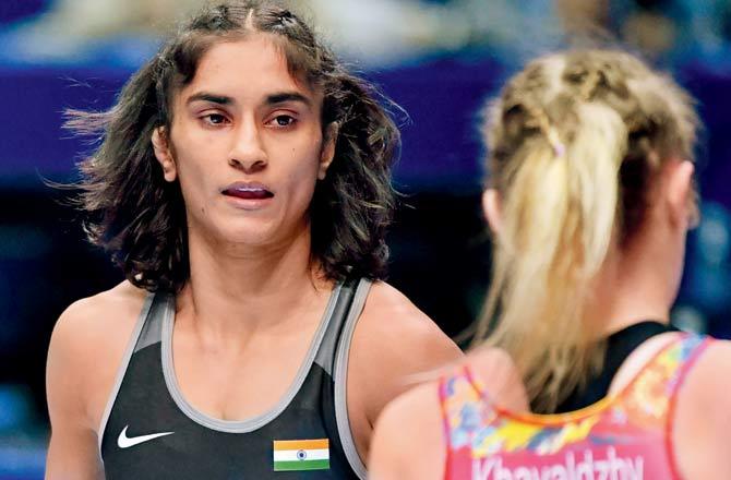 Vinesh Phogat (left) competes with Yuliia Khavaldzhy in the repechage round. Pic/PTI