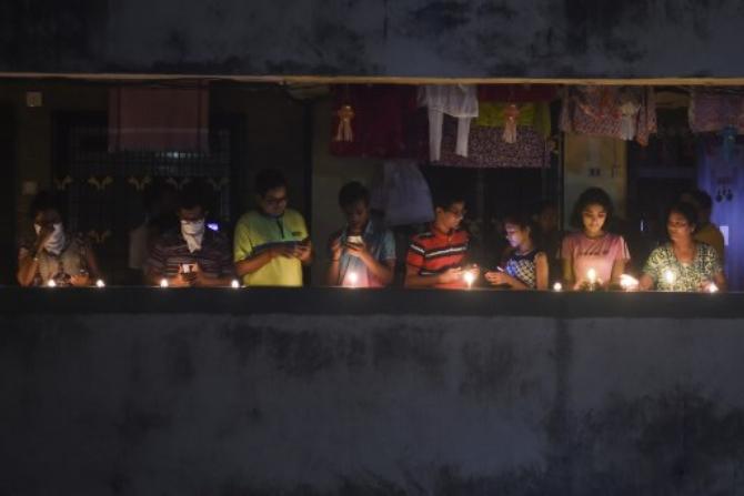 In Pune, many citizens switched off the lights and lit diyas or flashed torches inbuilt in their mobile phones. Some people even blew conchs while others shouted slogans like 'Bharat Mata ki Jai' and 'Go Corona Go'. Fire-crackers were burst at few places.
(Photo: AFP)