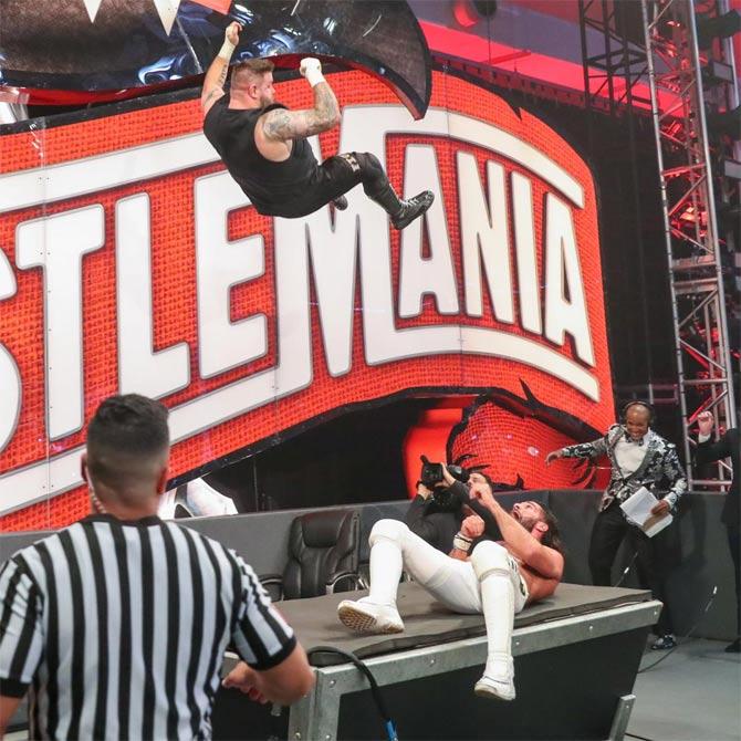 However, Kevin Owens wanted to end the match on his terms so he demanded a restart with it being No Disqualification. Kevin Owens would then go on the offence and after a death-defying leap off the WrestleMania 36 board onto the announcer's table onto Rollins, Owens hit the Stunner on Rollins to pick up the win.