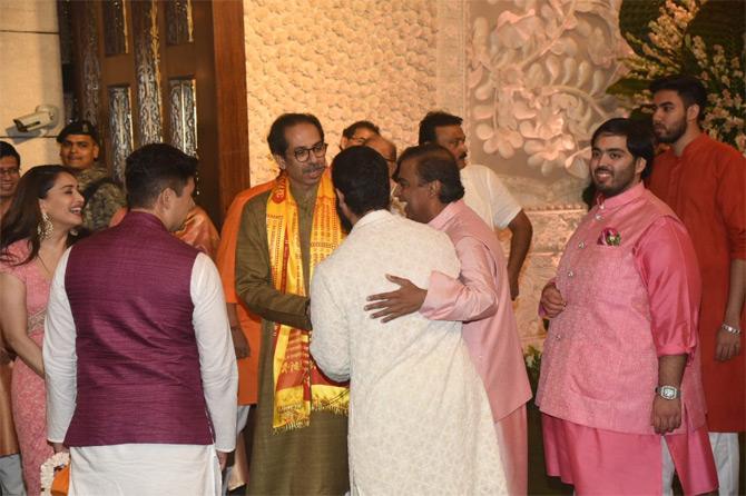In picture: Anant Ambani in a pink jacket and kurta looks on as Mukesh Ambani greets Maharashtra Chief Minister Uddhav Thackeray.