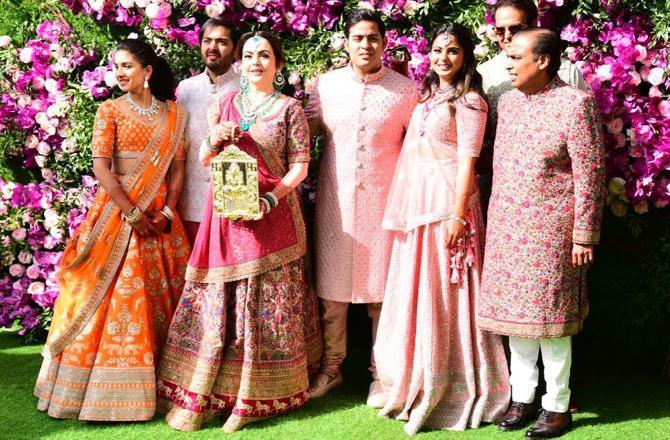 In Picture: The entire Ambani family pose together for Akash Ambani's wedding in pink attires. Anant Ambani's friend, Radhika Merchant was also spotted in the picture wearing an orange lehenga.