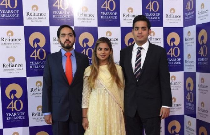 The three siblings were spotted together at the Annual General Meeting of the company. Anant was spotted wearing a blue shirt and a red tie.