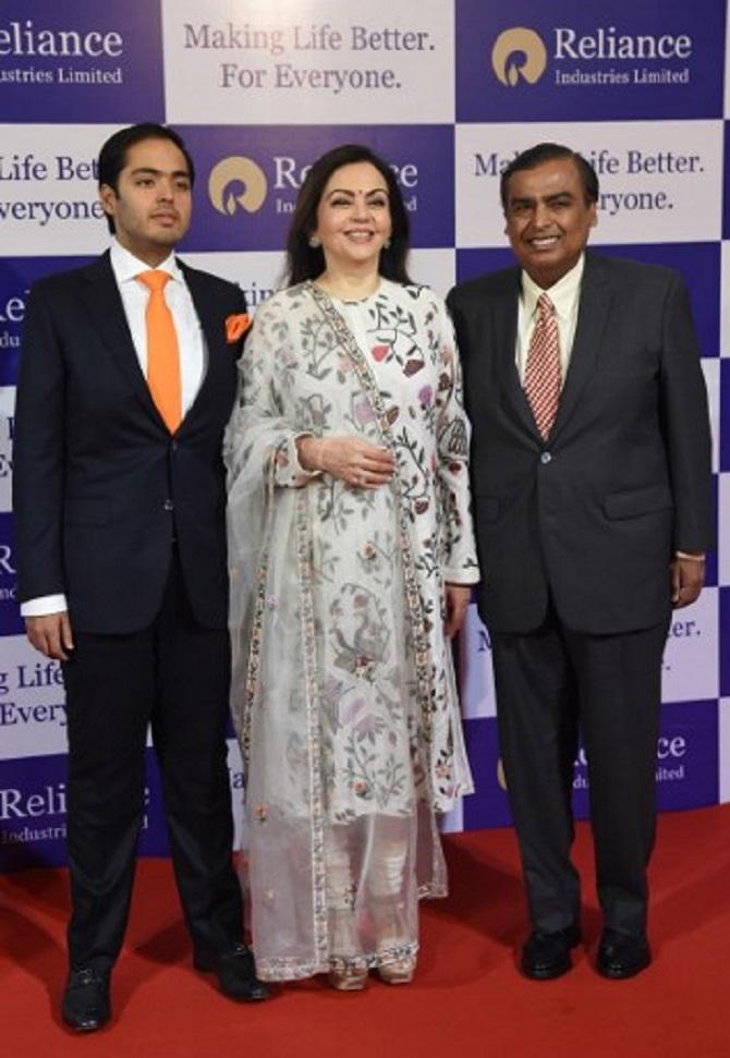 In picture: Nita Ambani and Mukesh Ambani clicked by the shutterbugs along with their son, Anant Ambani. While the two men wore suits, Nita Ambani wore a white salwar suit with a netted dupatta.