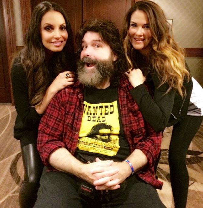 In picture: Lita and Trish Stratus with WWE legend Mick Foley