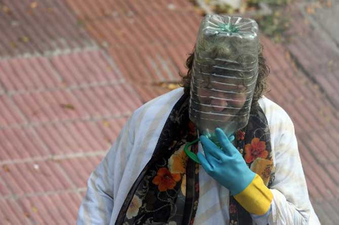 A woman wears a plastic water bottle to cover her face amid the spread of the coronavirus, COVID-19 disease, in Montevideo, Uruguay.