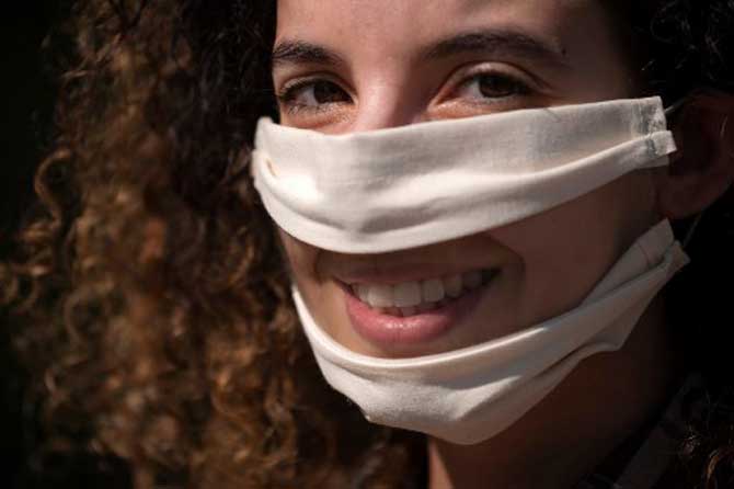 French leather creator Anissa Mekrabech, wearing the protective face mask she created for the deaf and the hearing-impaired people poses in Toulouse, southern France.