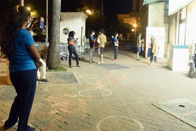 In photo: People follow social distancing as they shop for essentials outside DMart in Powai.