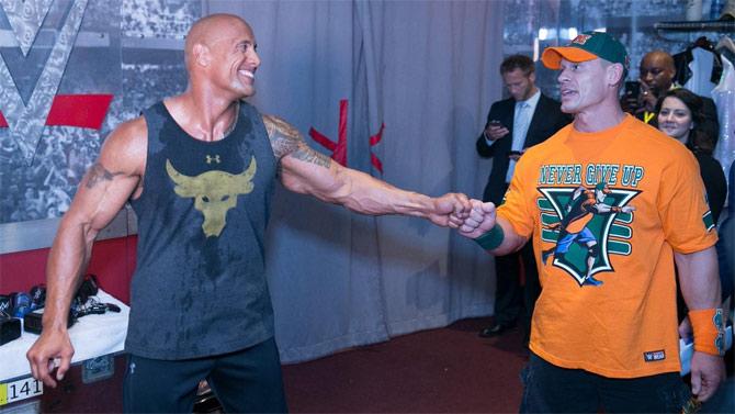 John Cena and Dwayne 'The Rock' Johnson faced each other in two back-to-back WrestleMania main events in 28 and 29 respectively. At WM 28 The Rock defeated Cena, but at WM 29, Cena defeated The Rock to become WWE champion in what was called a 'Passing the Torch' in WWE.
In picture: John Cena with The Rock backstage