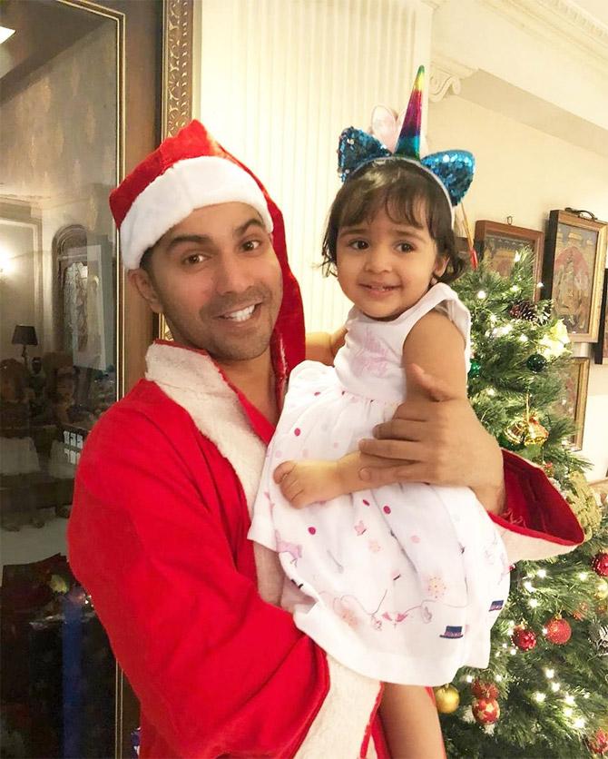 Wearing a Santa outfit, Varun Dhawan strikes a pose with his munchkin. The actor looks cute in Santa's avatar, doesn't he?