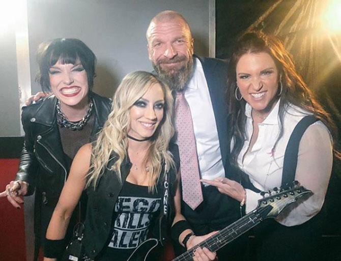 Ahead of WWE's first-ever women's pay-per-view Evolution, Triple H shared a photo with wife Stephanie McMahon and female guitarists Lizzy Hale and Nita Strauss.
