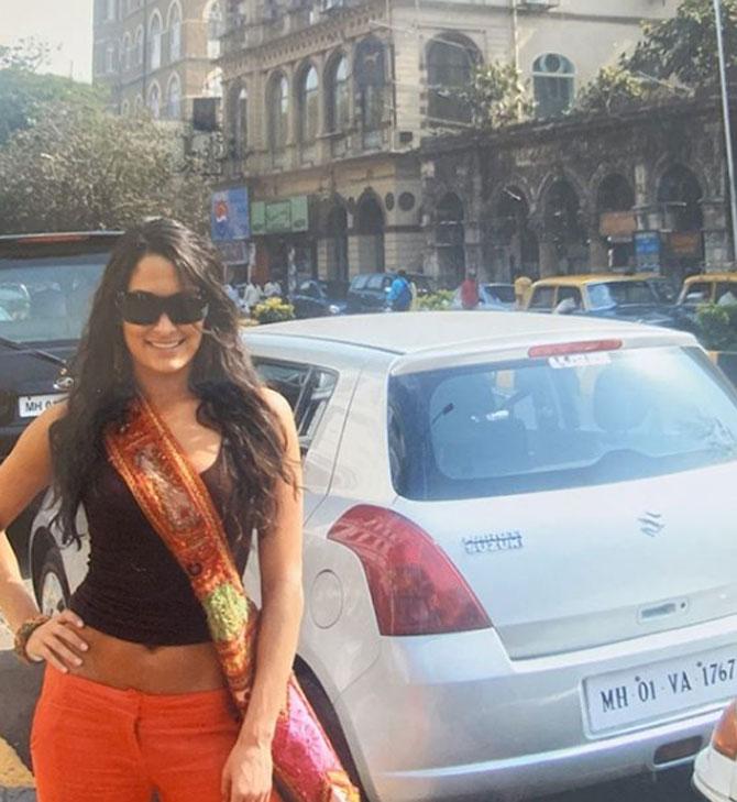 In picture: Nikki Bella smiles for the camera in a sleeveless top and orange trousers sporting sunglasses in Mumbai