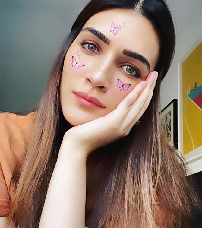 Kriti Sanon shared a photo of her with pink and green coloured eyeballs and butterfly stickers on her face. She captioned it: 