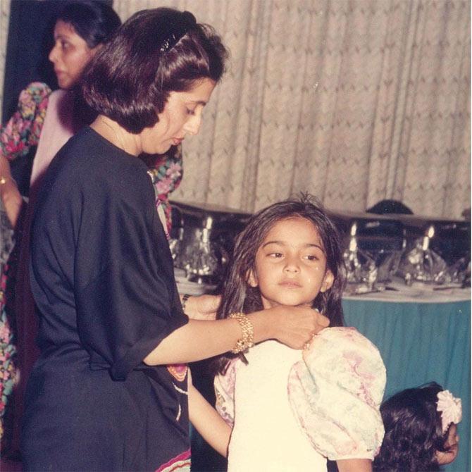 In this one, Sunita Kapoor is seen adjusting Sonam Kapoor dress. It seems like the mother-daughter duo was at a family function.