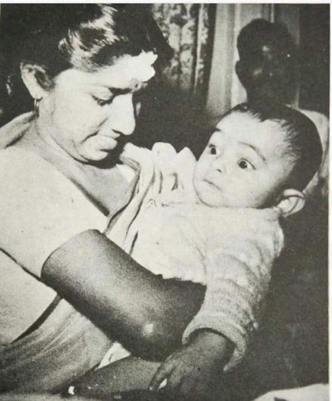 A vintage photo of three-four months old baby Rishi being cradled by none other than the incredible Lata Mangeshkar. The legendary singer can be seen holding a baby Rishi Kapoor in her arms as he looks on wide-eyed. 