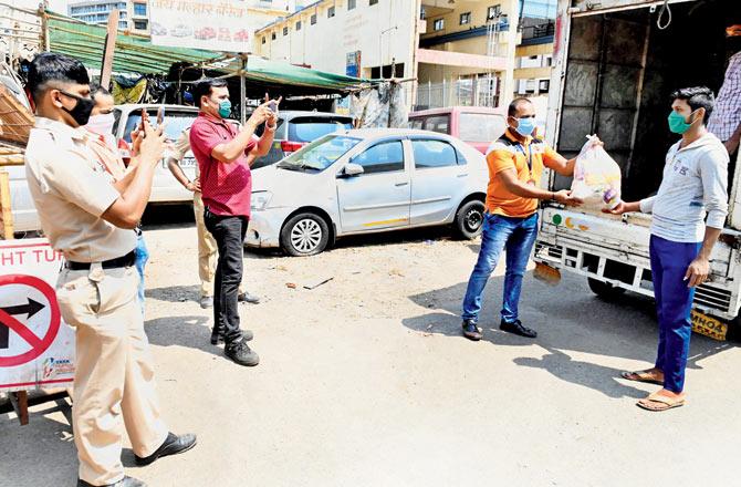 The police provided groceries to about 200 labourers from UP in Worli village on Tuesday. Pic/Bipin Kokate
