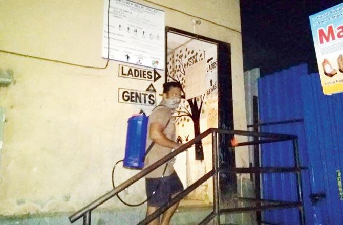 A public toilet being disinfected in Sahar Village