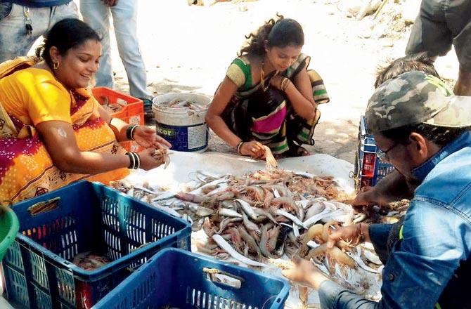 Fisherfolk sell their catch during the peak season last year