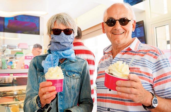A couple gets ice cream in Ludwigsburg as Germany relaxes curbs. Pic/AFP