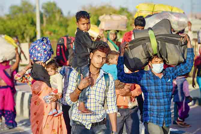 Migrant workers with family members return to their villages from New Delhi during a nationwide lockdown recently. pic/PTI